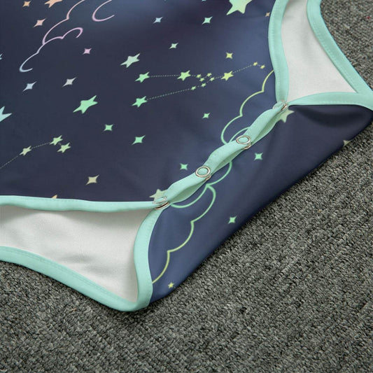 Celestial night adult onesie close-up detail showing mint trim, snap detail, and star fabric texture.