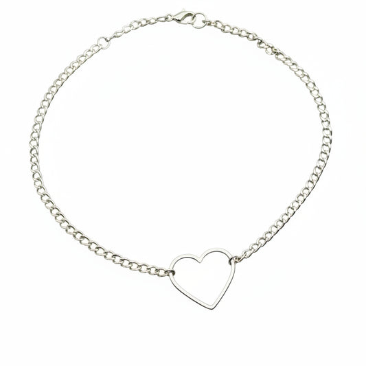 Silver curb chain choker necklace with hollow heart pendant on white background.